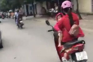 Video: Nữ tài xế vừa bế con vừa phóng xe máy vẫn thoải mái gác chân