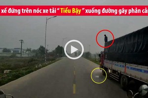 Video: Tài xế ôtô tải vô tư đứng trên nóc xe "tiểu bậy" xuống đường