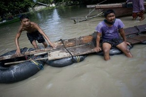 Dân Myanmar dùng can nhựa, săm xe... làm bè trong mưa lũ