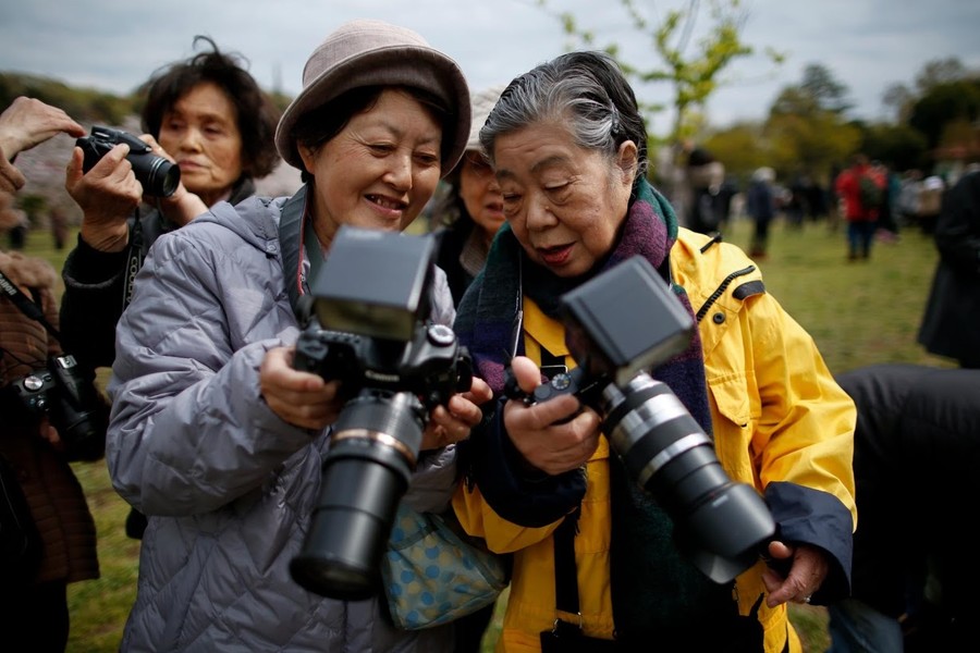 Hãng thống tấn Reuters đã chia sẻ câu chuyện về bà Fumiko Shirataki (phải) - một trong những người rất hâm mộ Hoàng gia Nhật Bản. Bất cứ nơi nào các thành viên Hoàng gia Nhật Bản đến, bà Fumiko đều cố gắng có mặt tại đó để chụp ảnh về họ. (Nguồn ảnh: Reuters)