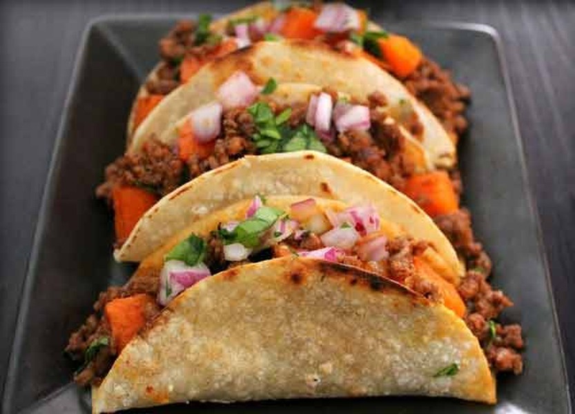 1. Tacos. Nó là loại bánh kẹp thịt với vỏ bánh được làm từ bột ngô còn nhân bánh được làm từ bất kỳ loại thịt nào như thịt lợn, thịt bò, thịt gà, cá nấu chín. Loại bánh này không thể thiếu được một chút sốt salsa và thường được ăn kèm với hành tây, rau mùi. Tacos có hai loại là vỏ bánh cứng và vỏ bánh mềm. Có rất nhiều loại bánh tacos nhưng loại tacos phổ biến nhất tại Mexico là Taco al Pastor. Nguyên liệu chính của Taco al Pastor là thịt lợn ướp gia vị, xiên que và nướng trên lửa.