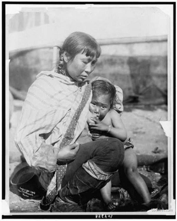 Một bà mẹ Inuit đang  cho con bú. Ảnh chụp năm 1908.