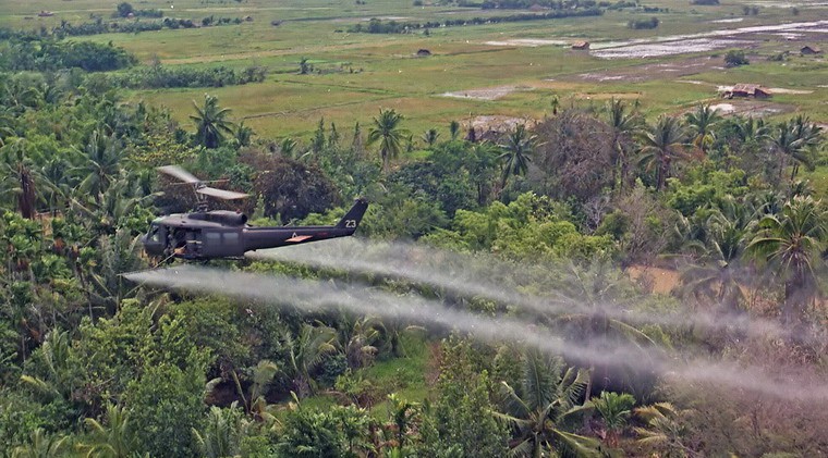  Một chiếc trực thăng UH-1D đang xịt thuốc làm rụng lá trên một khu rừng rậm ở đồng bằng sông Cửu Long trong cuộc chiến tranh Việt Nam. Ảnh: Bộ Quốc phòng Mỹ.