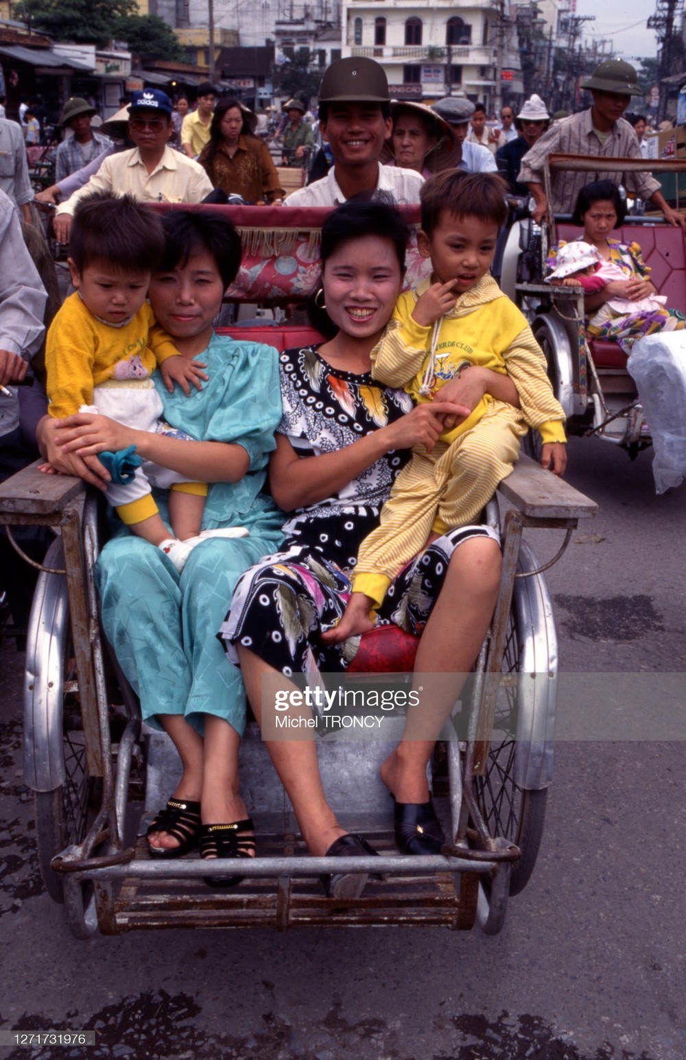 Phụ nữ và trẻ em trên xe xích lô ở Hà Nội,  Việt Nam thập niên 1990. Ảnh: Michel Troncy/ Getty Images.