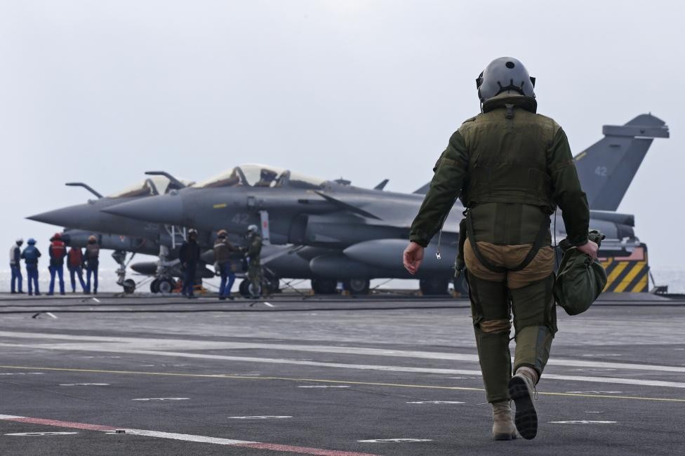 Một phi công đang tiến đến chiếc chiến đấu cơ Rafale trên  tàu sân bay Charles de Gaulle ở Vịnh Ba Tư để lên đường thực hiện nhiệm vụ ngày 29/1/2016.