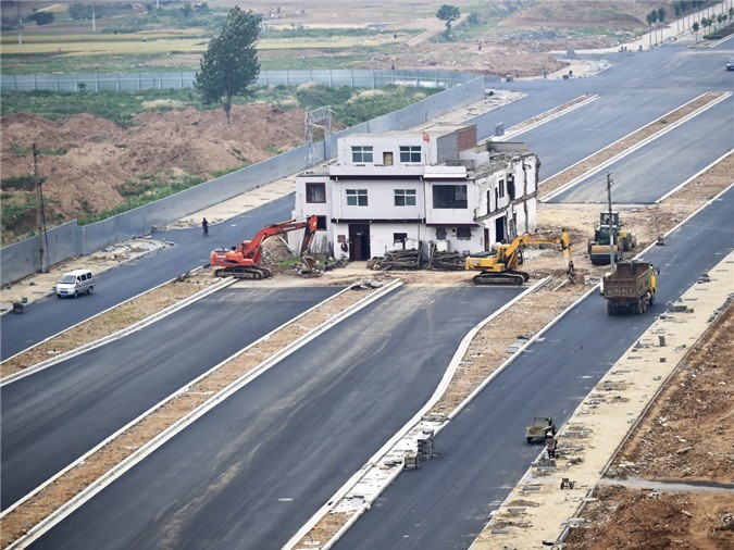 Một  ngôi nhà nằm ở giữa tuyến đường đang thi công tại Trung Quốc. Được biết, tuyến đường vẫn xây dựng, còn chủ nhà từ chối việc di dời. (Nguồn: Reuters)   