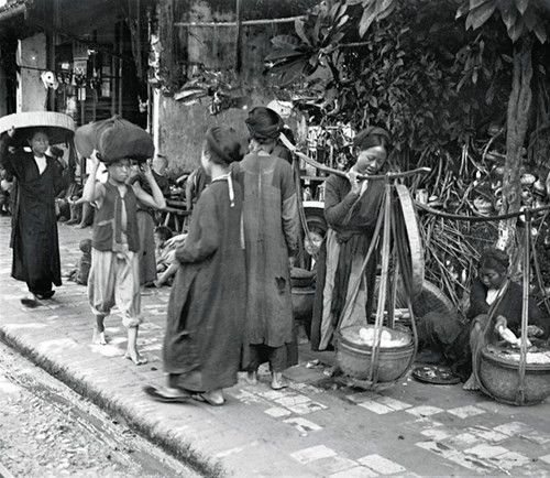 Những người bán rong trên  vỉa hè Hà Nội, khoảng năm 1922. Ảnh: Francetvinfo.fr