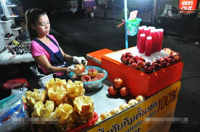 Đoàn khách Trung Quốc đã ghi lại hình ảnh về cuộc sống thường nhật ở  thành phố Bangkok trong chuyến đi vào đầu năm 2017. Ở đó, những xe bán hàng rong xuất hiện trên các con phố ở trung tâm Bangkok, góp phần tạo thêm một hình ảnh rất riêng của quốc gia Đông Nam Á này. Ảnh: Cô chủ sạp bán hàng rong đang tách quả lựu ra để làm đồ uống hoặc bán cho khách. Ảnh Sina