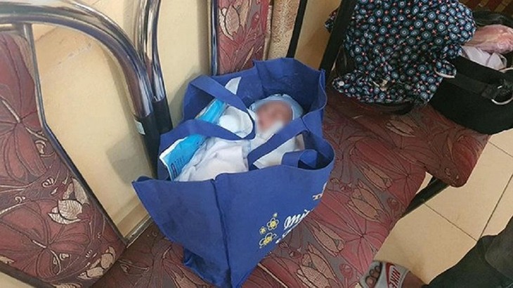 bé trai được để trong túi xách màu xanh, bên trong có 1 số đồ dùng của trẻ sơ sinh và một lá thư người mẹ để lại. be-trai2.jpg
