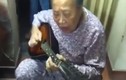 Cụ bà ôm đàn guitar hát một cách hào hùng