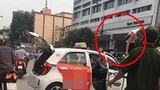 Bị CSGT "tuýt còi", tài xế taxi leo lên nóc xe ăn vạ