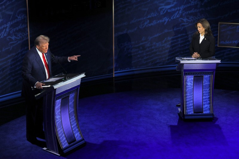 People watch the presidential debate between Trump and Harris, in New York