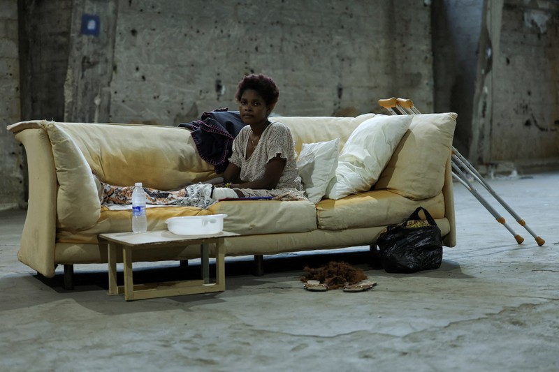 Fatmata Conteh, from Sierra Leone rests her broken leg on a couch at a shelter for displaced migrant workers in Hazmieh