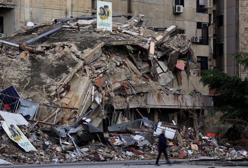 A man walks past near the rubble of a building in Beirut