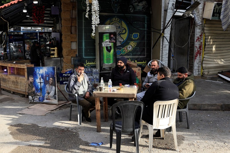 People sit at a cafe in Beirut's southern suburbs