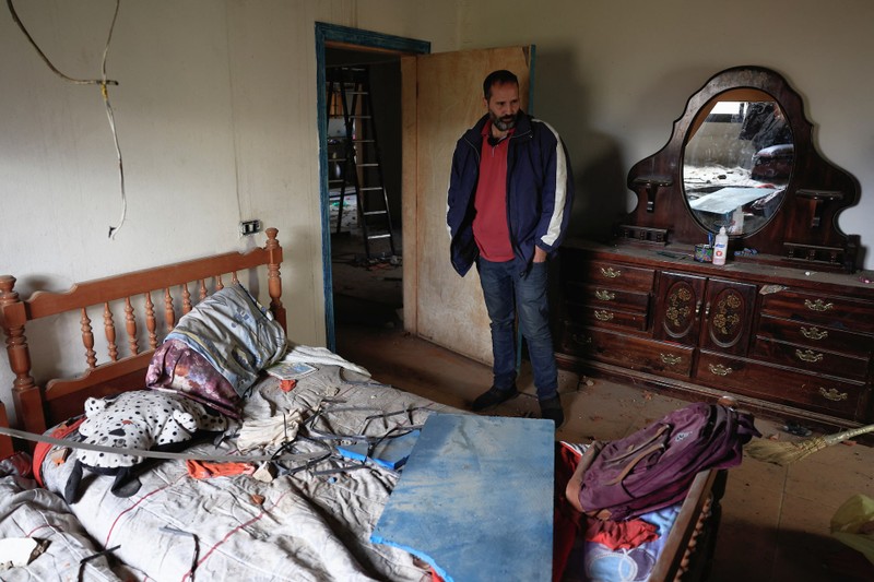 A resident of Baalbek, Abbas Wehbe, stands in a damaged room inside his house, in Baalbek