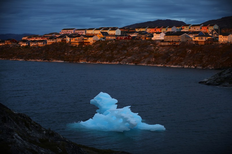 An icberg passes during sunset in Nuuk