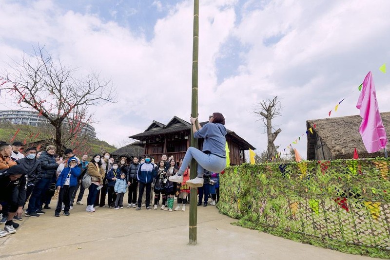 View - 	 Du khách thích thú bắt dê leo cột mỡ tại Hội Xuân Mở Cổng trời
